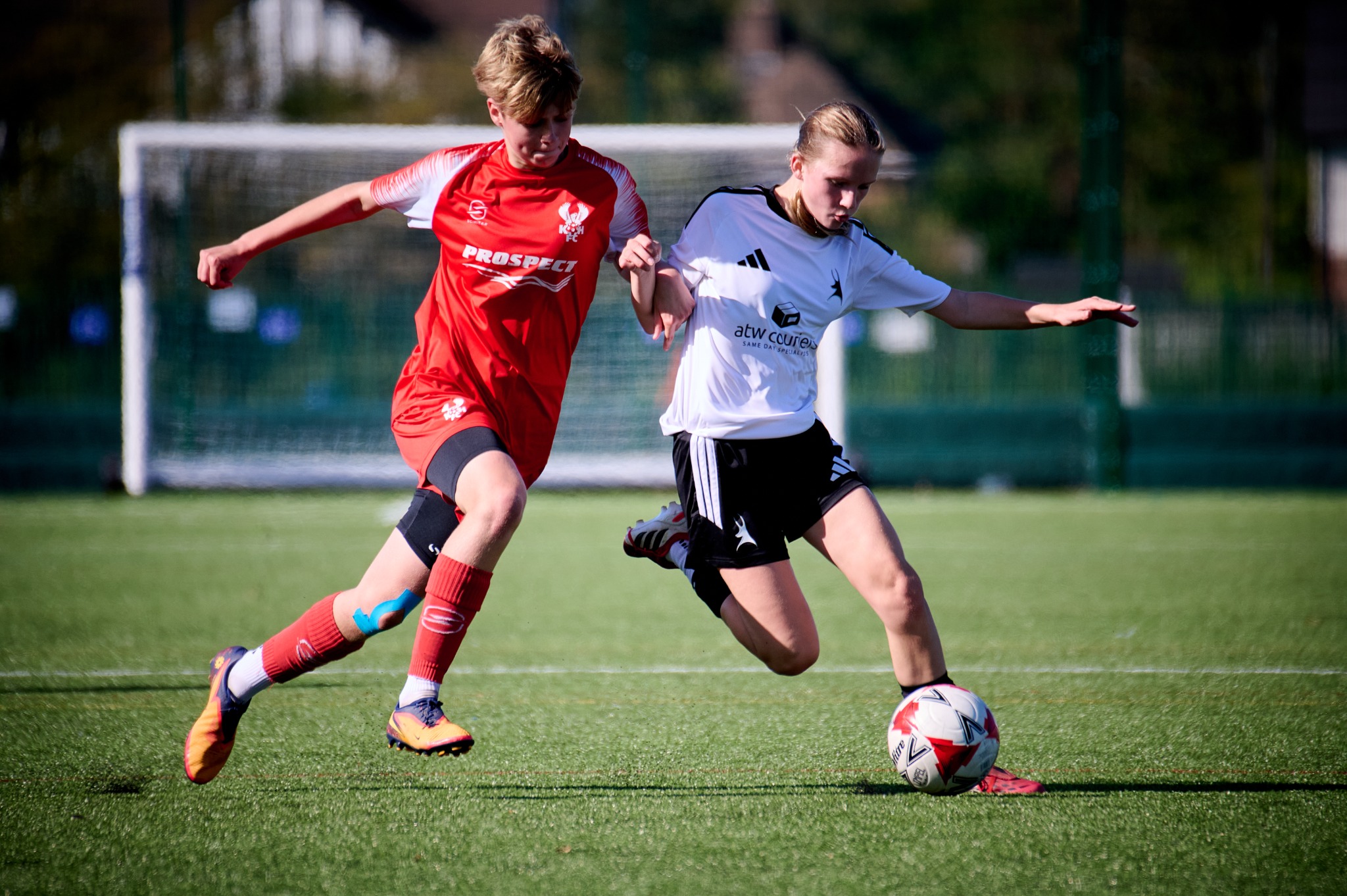 Two football players competing for the ball